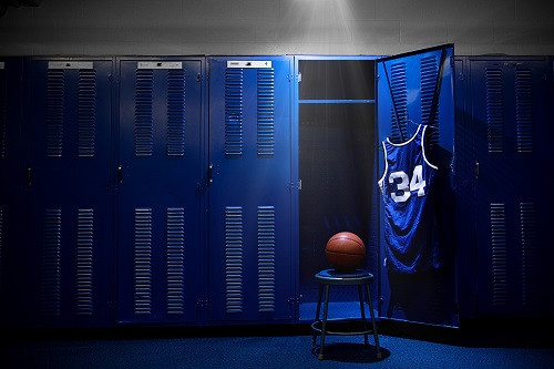 An open locker with a jersey and ball in a authentic basketball locker room. Lots of Copy Space