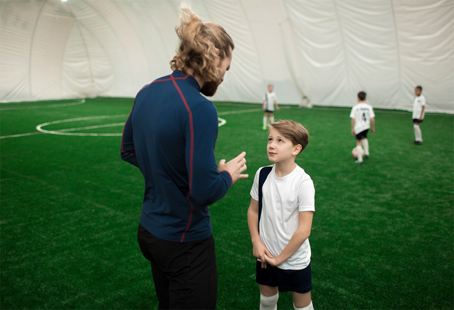 sports equipment disinfectant spray kid talking to trainer